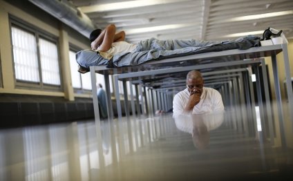 A detainee lies in his bunk at